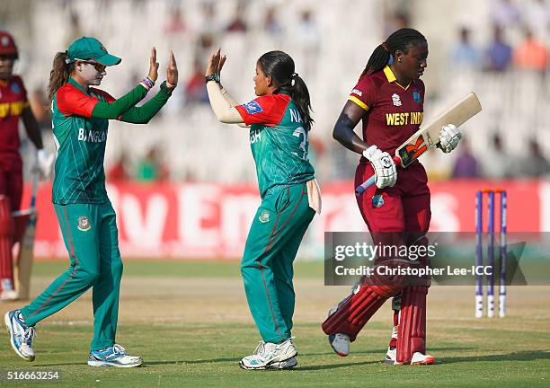 Nahida Akter of Bangladesh celebrates with Jahanara Alam, Captain of Bangladesh after she takes the wicket of Stafanie Taylor, Captain of the West...