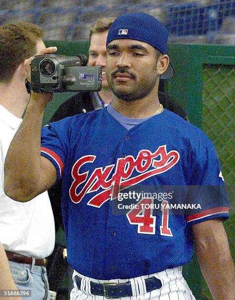 Venezuela's baseball player Ugueth Urbina of Montreal Expos uses his camcorder during the official training of the US-Japan All Star Series in Tokyo...