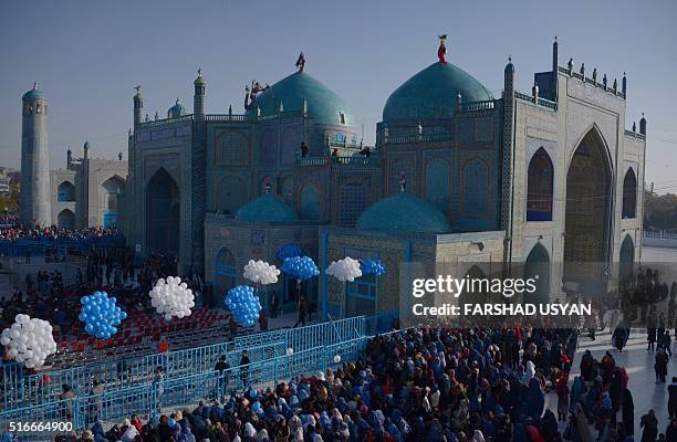 Afghan devotees gather in front of the Hazrat-e-Ali shrine for Nowruz festivities which mark the Afghan new year in Mazari-i-Sharif on March 20,...