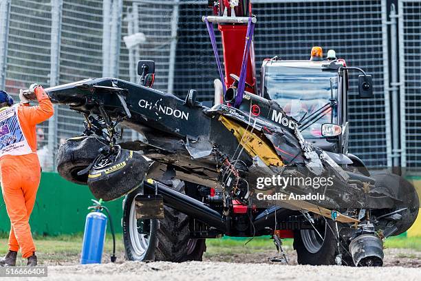 The destroyed car of Fernando Alonso of McLaren-Honda after his serious crash gets craned away during the qualifying of the 2016 Formula 1 Rolex...