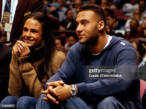 New York Yankee shortstop Derek Jeter and actress Jordana Brewster sit courtside 19 December 2002 at Continental Arena in East Rutherford, New...