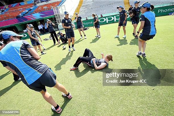 Team mates laugh as Katie Perkins of New Zealand take a tumble during a warm up ahead of the Women's ICC World Twenty20 India 2016 match between New...