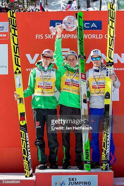 March 20: Severin Freund of Germany, Peter Prevc of Slovenia and Kenneth Gangnes of Norway pose for a picture during the victory ceremony of the...