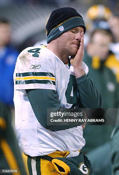 Green Bay Packers' quarterback Brett Favre rubs his eyes while standing on the sidelines in the fourth quarter of the Jets' 42-17 win over the...