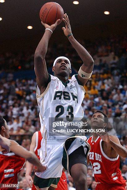 St. Vincent-St. Mary's LeBron James goes up for a basket past Mater Dei's Wesley Washington , Chris Henry and Marcel Jones in the first quarter, in...