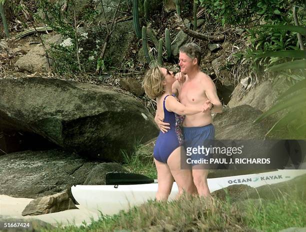 File photo dated 04 January 1998 shows US President Bill Clinton and First Lady Hillary Clinton dancing on the beach of Megan Bay, St. Thomas, US...