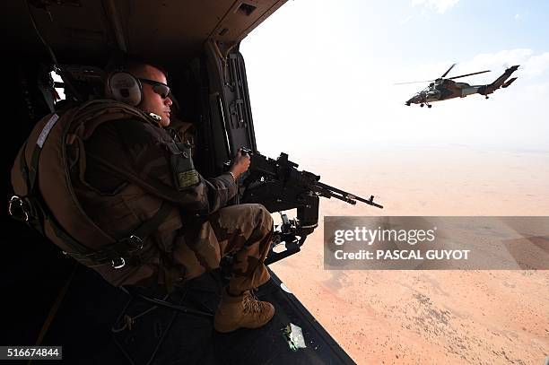 French soldier of the operation Barkhane, an anti-terrorist mission in Sahel, patrols as a tiger helicopter operates a tactical flight on March 12,...