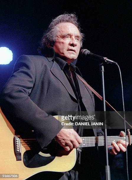 Photo taken 16 April 1997 in Bourges of US country singer Johnny Cash performing during the Printemps de Bourges Festival. Johnny Cash died at the...