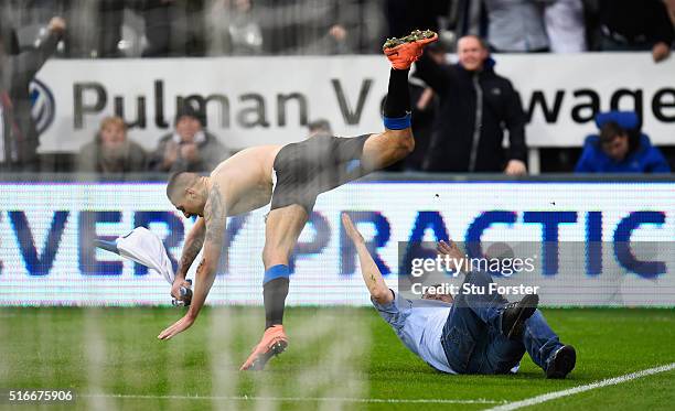 Aleksandar Mitrovic of Newcastle United collides with a fan as he celebrates scoring their first and equalising goal during the Barclays Premier...