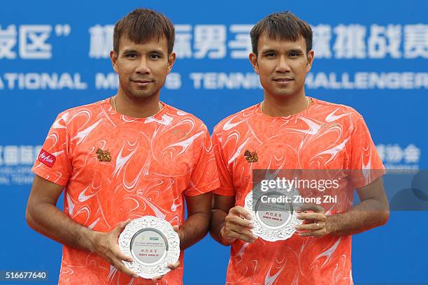 Sanchai Ratiwatana of Thailand and Sonchat Ratiwatana of Thailand with their trophy after losing the doubles final match against Denys Molchanov of...