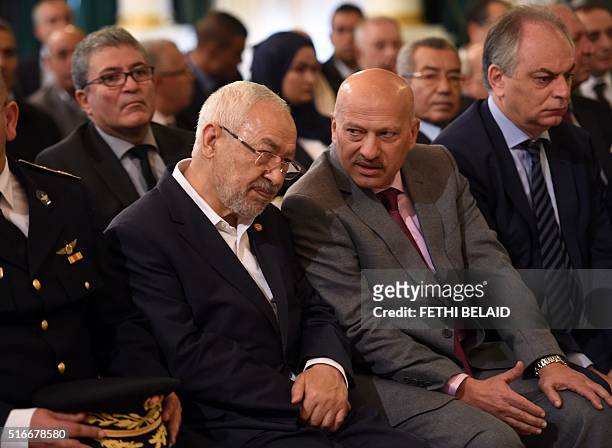 Tunisian Islamist Ennahdha party leader, Rached Ghannouchi , talks with Vice-President of Nidaa Tounes Ridha Belhaj during a ceremony marking the...