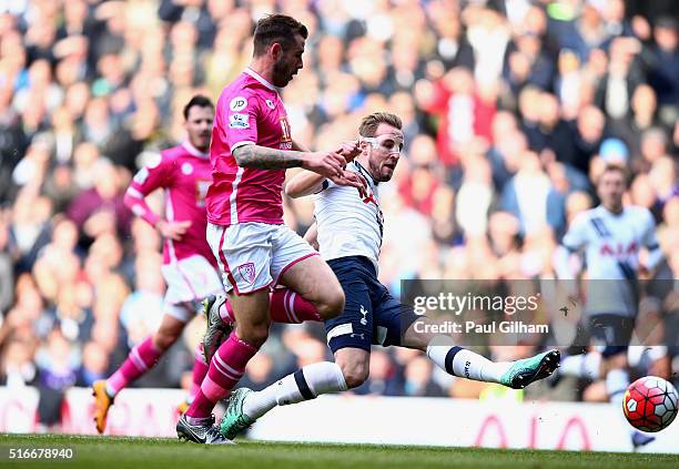 Harry Kane of Tottenham Hotspur beats Steve Cook of Bournemouth as he scores their second goal during the Barclays Premier League match between...