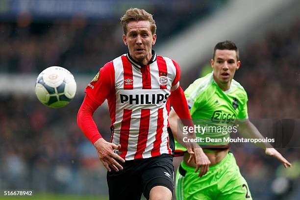 Luuk de Jong of PSV gets past the tackle from Nick Viergever of Ajax during the Eredivisie match between PSV Eindhoven and Ajax Amsterdam held at...