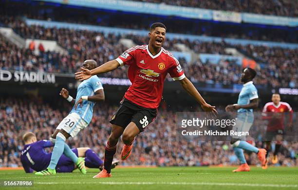 Marcus Rashford of Manchester United celebrates as he scores their first goal during the Barclays Premier League match between Manchester City and...