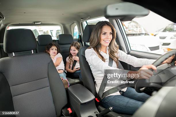 woman driving a car - kid car safety stock pictures, royalty-free photos & images