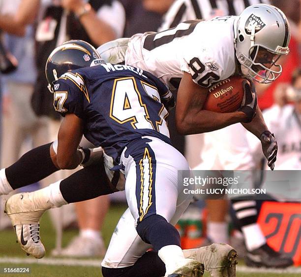 Oakland Raiders' wide receiver Jerry Rice is tackled on a 12-yard rush by San Diego Chargers' Ryan McNeil in the third quarter of their NFL game in...