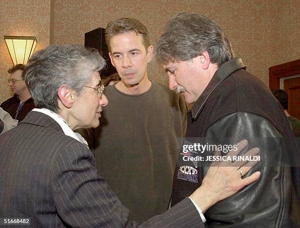 Sister Marie LaBollita of Our Lady Help of Christians in Newton, MA puts a gentle hand on Bernie McDaid's shoulder as she speaks with both McDaid and...