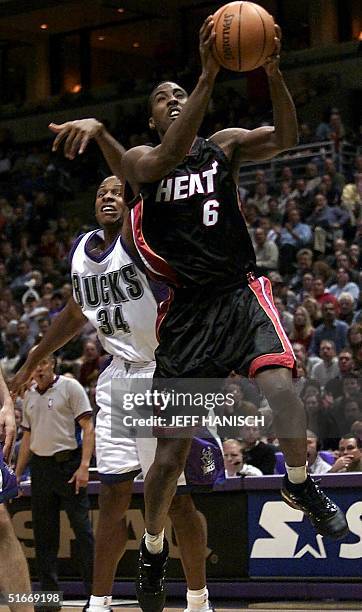 Eddie Jones of the Miami Heat shoots after beating Ray Allen of the Milwaukee Bucks during the second half 19 November 2002 at the Bradley Center in...