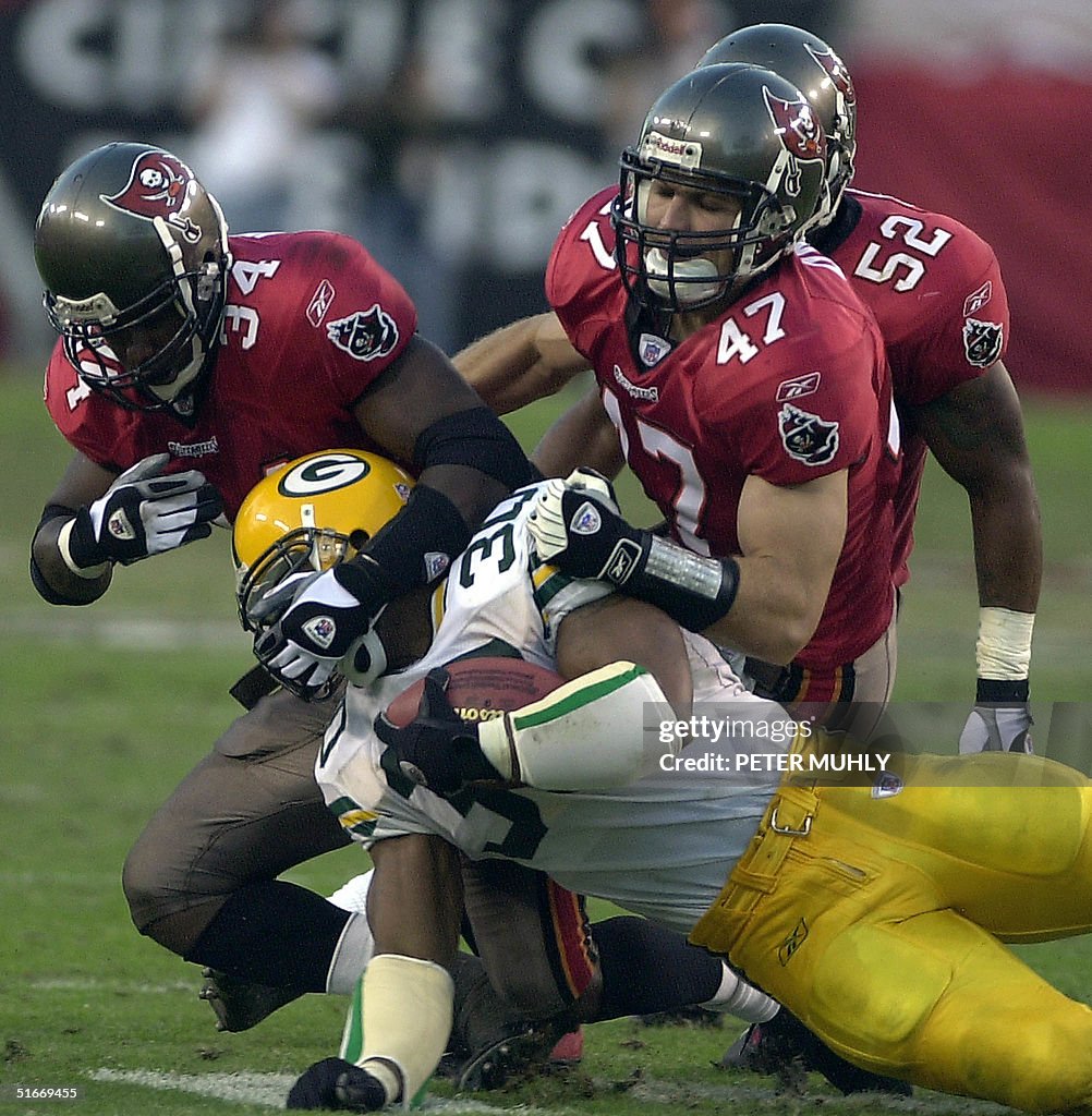 Green Bay Packers Ahman Green (front) is brought d
