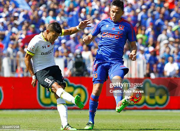 Esteban Pavez of Colo Colo fights for the ball with Gustavo Canales of U de Chile during a match between U de Chile and Colo Colo as part of...