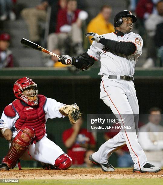 San Francisco Giants slugger Barry Bonds watches the ball after hitting a solo run homerun as Anaheim Angels catcher Bengie Molina watches in the...