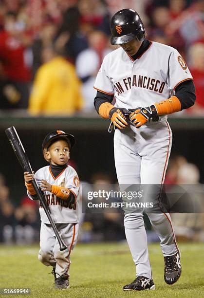 San Francisco Giants' batboy Darren Baker carries the bat of Tsuyoshi Shinjo after he struck out swinging in the ninth inning of Game Seven of the...