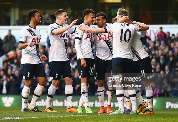 Christian Eriksen of Tottenham Hotspur celebrates with team mates as he scores their third goal during the Barclays Premier League match between...