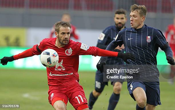 Marko Devic of FC Rubin Kazan is challenged by Evgeni Gapon of FC Mordovia Saransk during the Russian Premier League match between FC Rubin Kazan and...