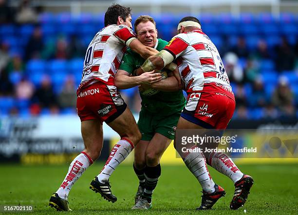 Greig Tonks of London Irish is tackled by John Afoa and James Hook of Gloucester during the Aviva Premiership match between London Irish and...