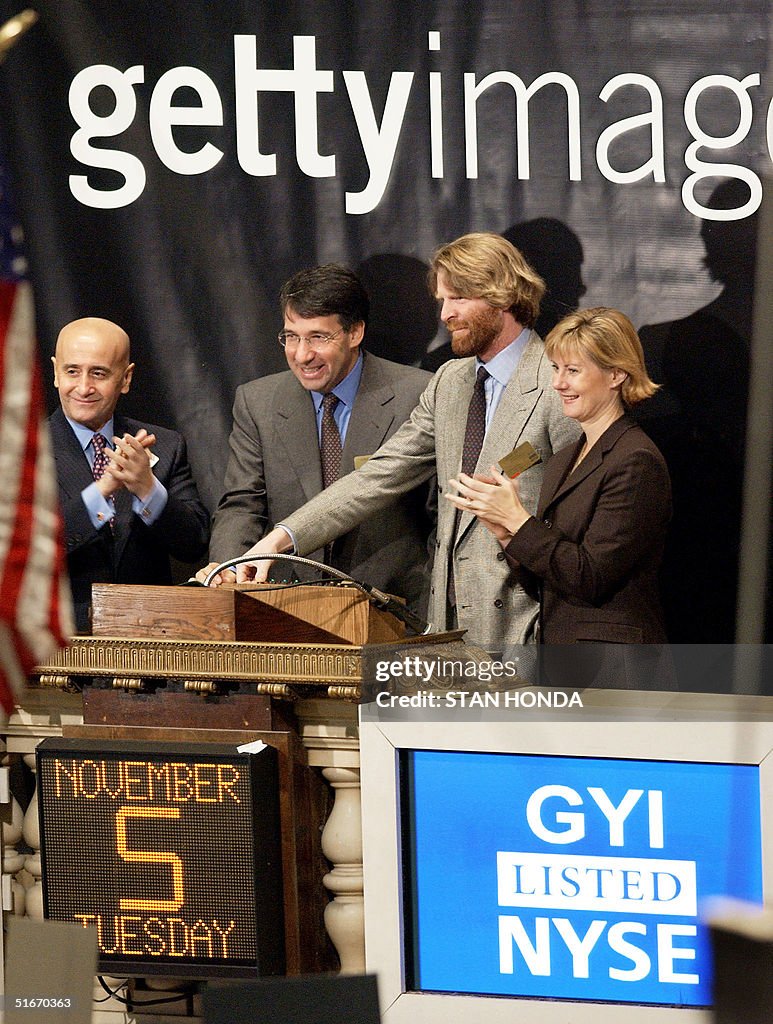 Mark Getty, Chairman of Getty Images (2nd R) rings