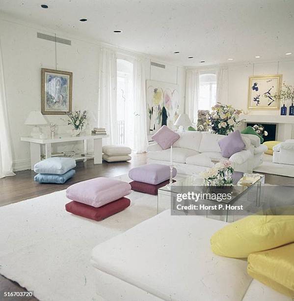 All-white living room in a New York apartment designed by owners architect Keith Kroeger and interior designer Filippa Naess, with white rug and...