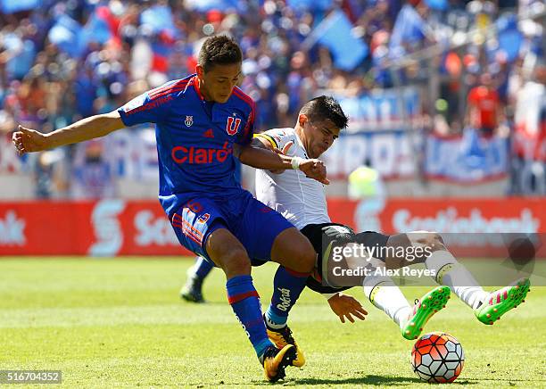 Matias Rodriguez of U de Chile fights for the ball with Esteban Pavez of Colo Colo during a match between U de Chile and Colo Colo as part of...