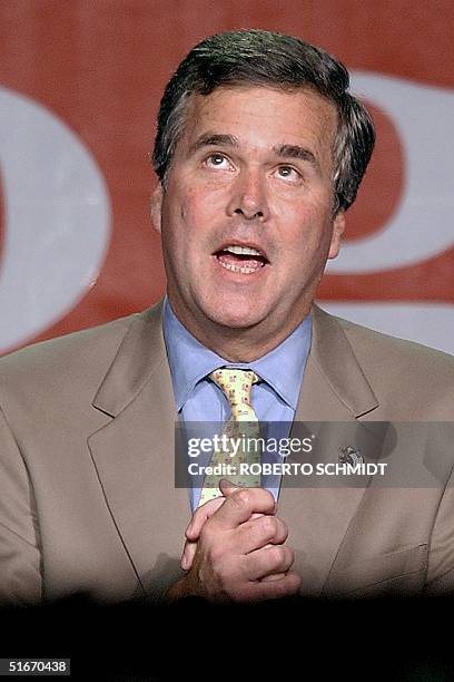 Florida Governor Jeb Bush holds his hands together as he looks up in a gesture thanking God moments before he announced that his Democratic opponent...