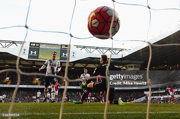 Christian Eriksen of Tottenham Hotspur scores their third goal past goalkeeper Artur Boruc of Bournemouth during the Barclays Premier League match...