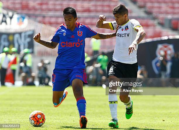Fabian Carmona of U de Chile fights for the ball with Esteban Pavez of Colo Colo during a match between U de Chile and Colo Colo as part of...