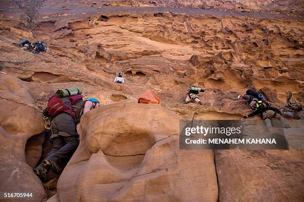 Group of Israeli hikers climb Jabel Rum on March 18, 2016 in the southern Jordanian desert in an area known as Wadi Rum or the Valley of the Moon,...