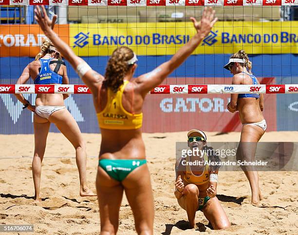 Larissa Franca and Talita Antunes of Brazil celebrate their victory after winning the final match against the United States at Camburi beach during...