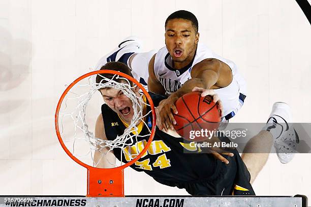 Adam Woodbury of the Iowa Hawkeyes goes up against Phil Booth of the Villanova Wildcats in the second half during the second round of the 2016 NCAA...