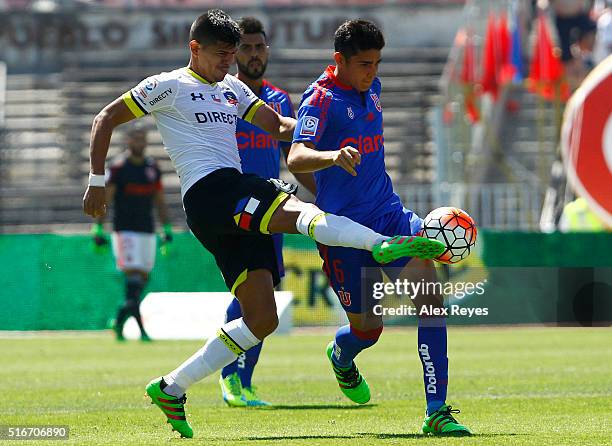 Esteban Pavez of Colo Colo fights for the ball with Sebastian Martinez of U de Chile during a match between U de Chile and Colo Colo as part of...