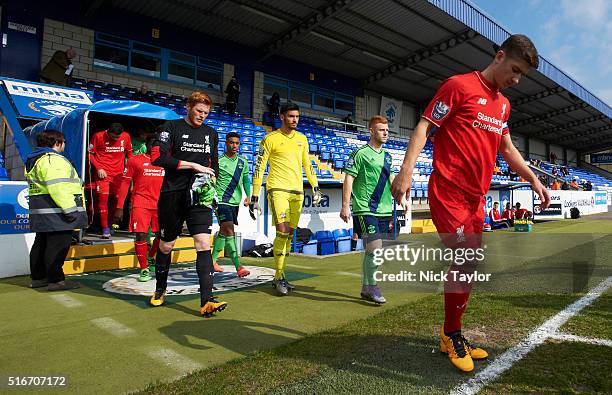 Captain Cameron Brannagan of Liverpool is followed by his goalkeeper Adam Bogdan and captain Harrison Reed and Paulo Gazzaniga of Southampton make...