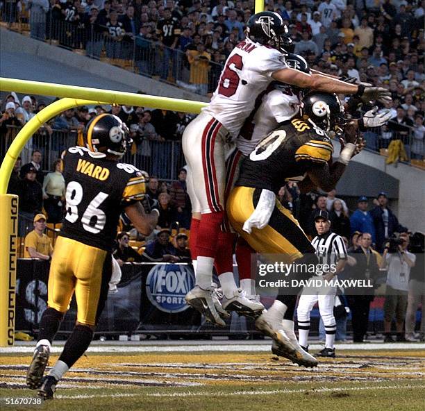 Pittsburgh Steelers receiver Hines Ward watches as teammate Plaxico Burress catches a Hail Mary pass from quarterback Tommy Maddox under Atlanta...