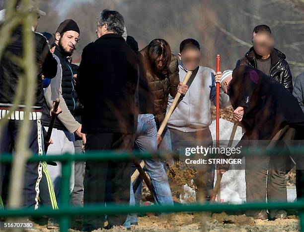 Relatives and friends, including Abid Aberkan , attend the burial ceremony of Brahim Abdeslam, one of the attackers of the November 13 Paris attacks,...