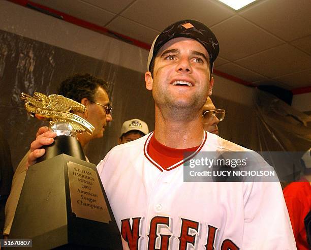 Adam Kennedy of the Anaheim Angels who hit three home runs holds the American League Champions trophy after the Angels defeated the Minnesota Twins...