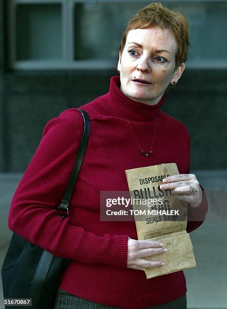 Elisabeth "Buffy" Maddux, a sister of Holly Maddux, holds a bag at a press conference following a day of testimony by accused killer Ira Einhorn 14...