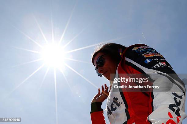 Danica Patrick, driver of the TaxACT Chevrolet, walks on the grid before the NASCAR Sprint Cup Series Auto Club 400 at Auto Club Speedway on March...