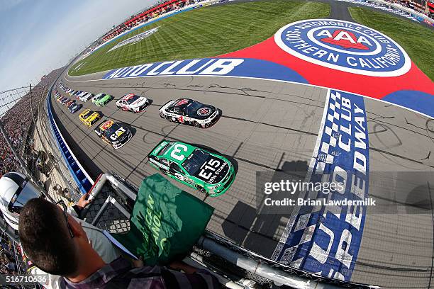 Austin Dillon, driver of the American Ethanol Chevrolet, and Kevin Harvick, driver of the Jimmy John's Chevrolet, lead a pack of cars at the start of...