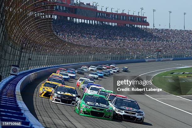 Austin Dillon, driver of the American Ethanol Chevrolet, and Kevin Harvick, driver of the Jimmy John's Chevrolet, lead a pack of cars at the start of...