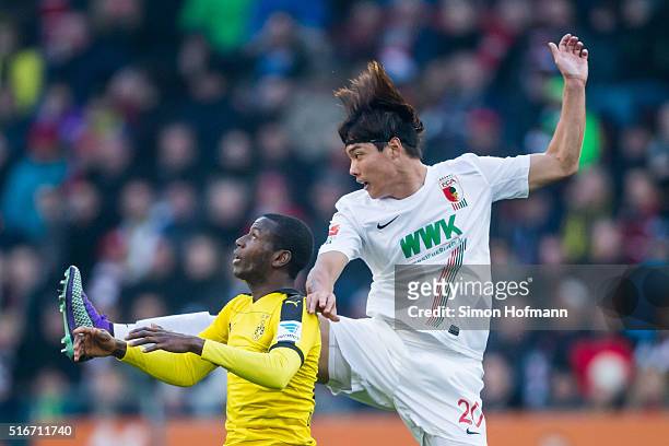 Jeong-Ho Hong of Augsburg jumps for a header with Adrian Ramos of Dortmund during the Bundesliga match between FC Augsburg and Borussia Dortmund at...