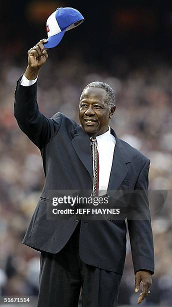 All time home run record holder Hank Aaron tips his hat to the crowd before Game Four of the World Series Between the Anaheim Angels and the San...