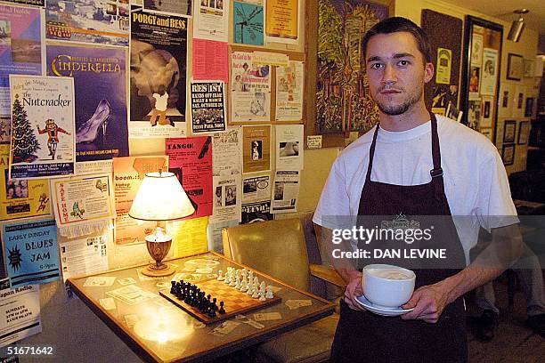 Mark Wendover, assistant manager of Stuart's Coffee House in Bellingham, Washington, 85 miles north of Seattle, stands next to a chess board in the...